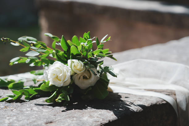 istock Small bouquet of flowers placed on a low wall. 1404380905