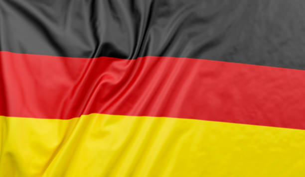 istock German flag blowing in the wind. Germany flag full page 1404381346
