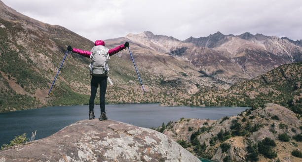 istock Woman backpacker hiking in beautiful winter mountains 1404381681