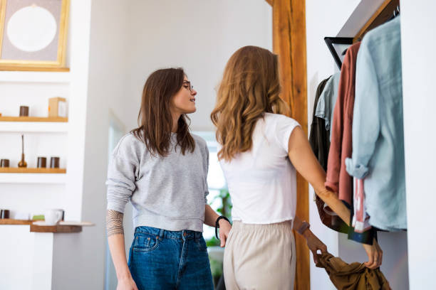 istock Two young women going through clothes from their wardrobe at home 1404381734