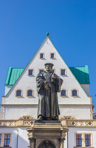 Statue of Martin Luther in front of the historic town hall of Eisleben, Germany