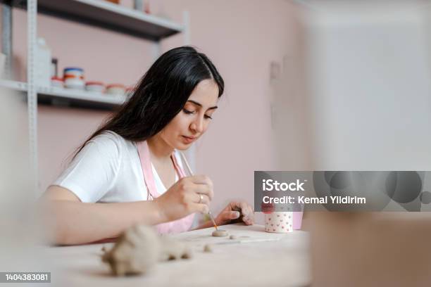 Beautiful Woman Kneading Clay In Workshop Stock Photo - Download Image Now - Pottery, Hobbies, Women