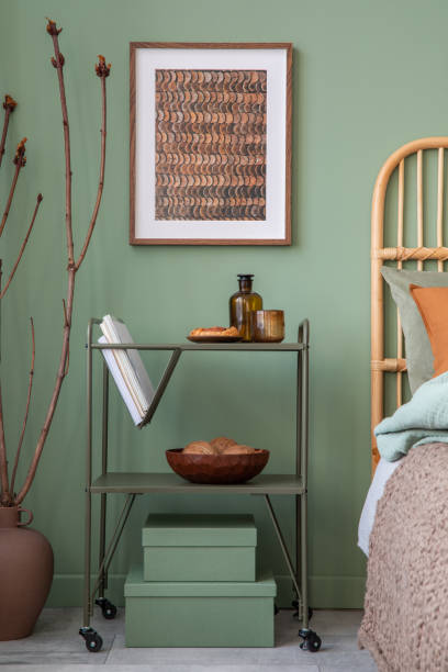 istock Stylish bedroom interior design with mock up poster frame, bamboo bed, metal shelf and creative home accessories. Eucalyptus wall. Home staging. Template. Copy space. 1404384097