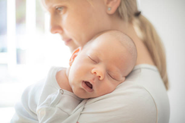 istock Baby sleeping on his mother's shoulder 1404384483