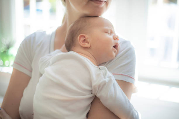 istock New mom holding her baby boy 1404384515