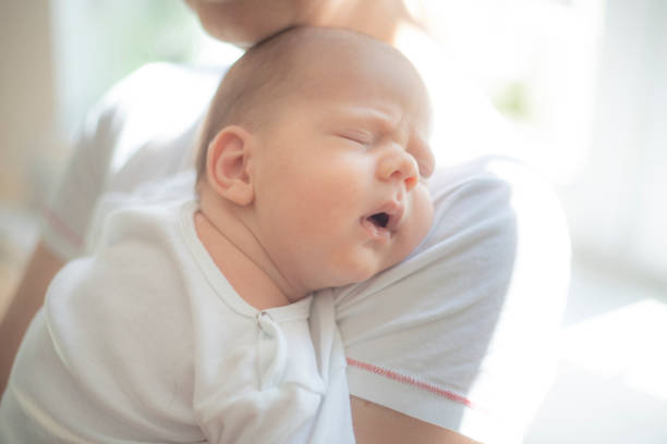 istock Baby sleeping on his mother's shoulder 1404384536
