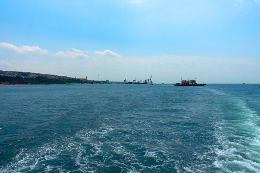 Istanbul, Turkey - May 18, 2022; Ferry in Bosphorus,  Haydarpasa Port and city view background