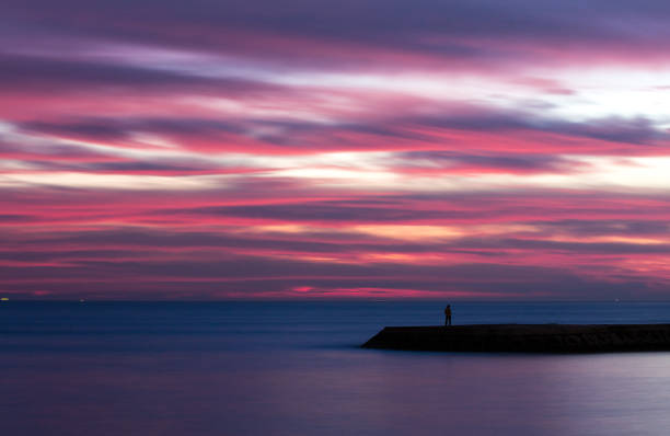 istock Purple sunset over by the sea 1404393018