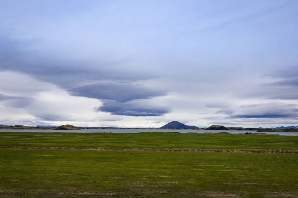 istock Icelandic fields with a lake and volcanic crater on the distant horizon 1404394056