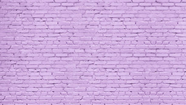 Old rough lavender color painted brick wall texture. Pastel purple exterior brickwork. Abstract textured background