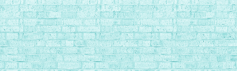 Light turquoise shabby color old rough brick wall wide texture. Old bright teal masonry widescreen backdrop. Pastel aquamarine vintage brickwork panoramic background