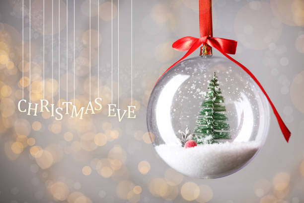 istock Christmas Eve, postcard design. Decorative bauble against blurred festive lights 1404398632
