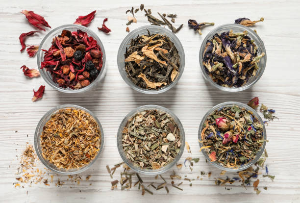 istock Flat lay composition with different dry teas on white wooden table 1404401233