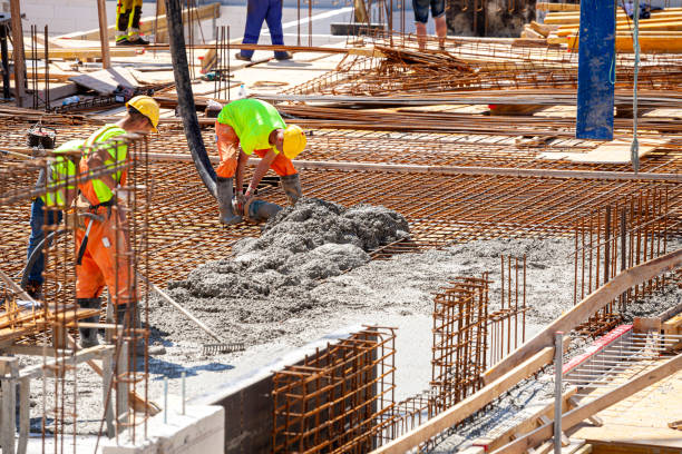 Concrete pouring on the construction site. stock photo