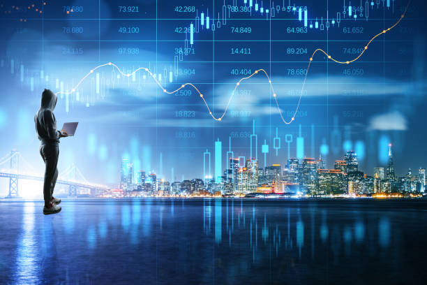 Crypto currency exchange and impersonal transactions concept with person in hoody back view with laptop and growing virtual hologram stock market statistics on night city skyline background stock photo
