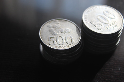 several piles of five hundred rupiah coins