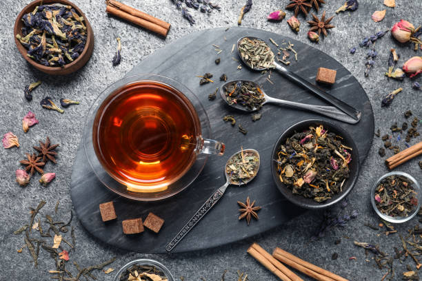 istock Flat lay composition with freshly brewed tea and dry leaves on grey table 1404403205