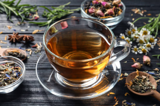 istock Composition with freshly brewed tea and different leaves on black wooden table, closeup 1404403962