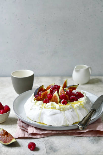 Homemade delicious meringue cake "Pavlova" with figs and fresh raspberry .