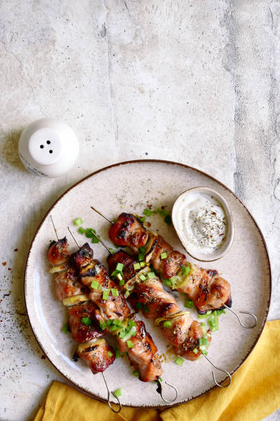 istock Roasted chicken kebab or souvlaki. Top view with copy space. 1404408732