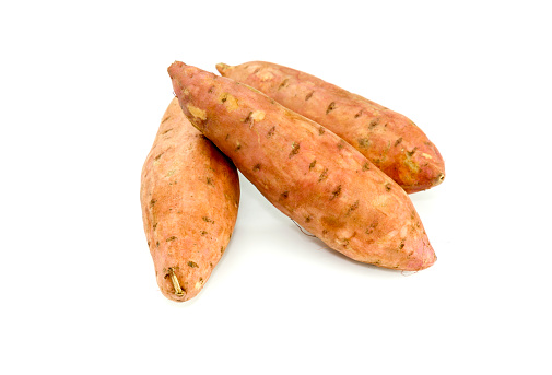 Three root vegetables raw, untreated, sweet potato on white background close-up