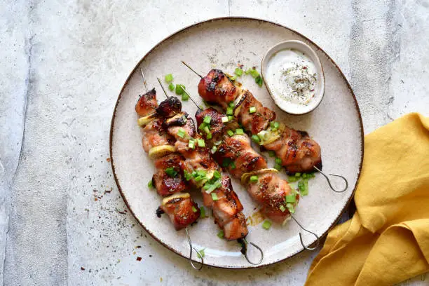 Photo of Roasted chicken kebab or souvlaki. Top view with copy space.