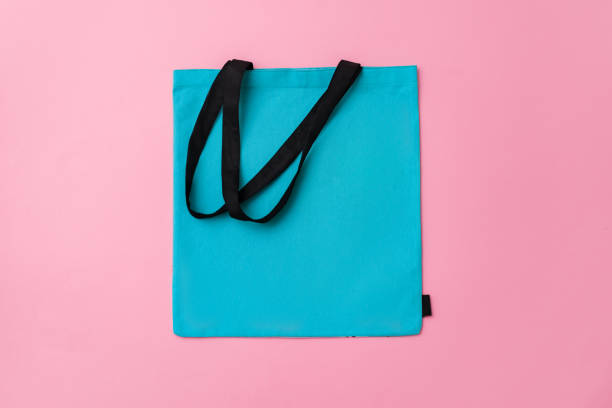 istock Textile shopping bag on pink paper background flat lay 1404411988
