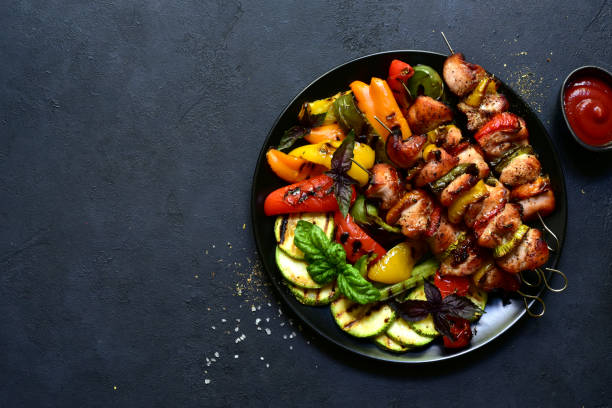 istock Chicken kebab skewers with grilled vegetables. Top view with copy space. 1404412169
