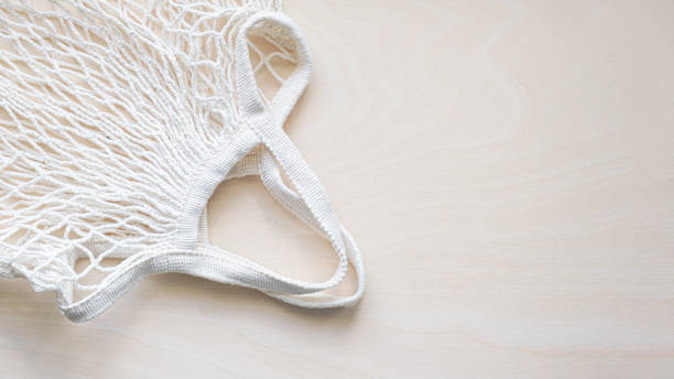 istock Eco friendly mesh bag on a light wooden background 1404412913