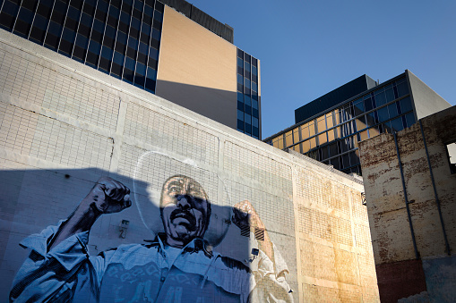 El Paso, Texas, USA - June 15, 2022: The morning sun rises on a mural of a Mexican man in the downtown district of El Paso, Texas.