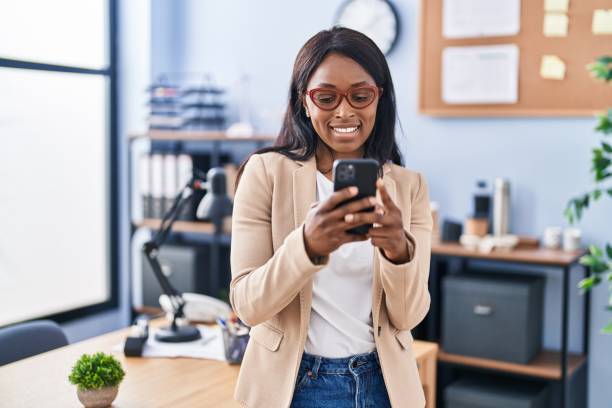 istock Young african american woman business worker using smartphone at office 1404416794