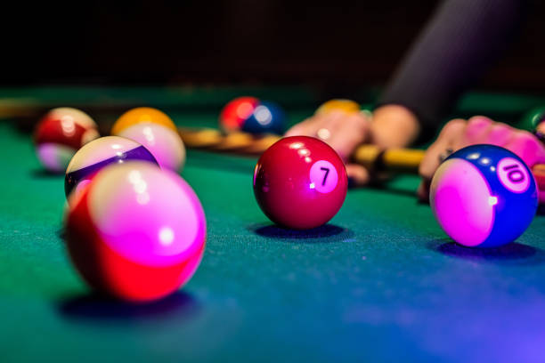 istock Old billiard ball and stick cue on a green table. 1404417890