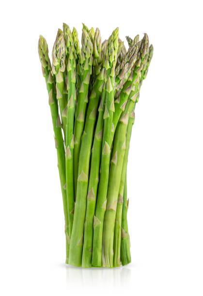 istock Bunch of green raw asparagus isolated on white background. 1404418075