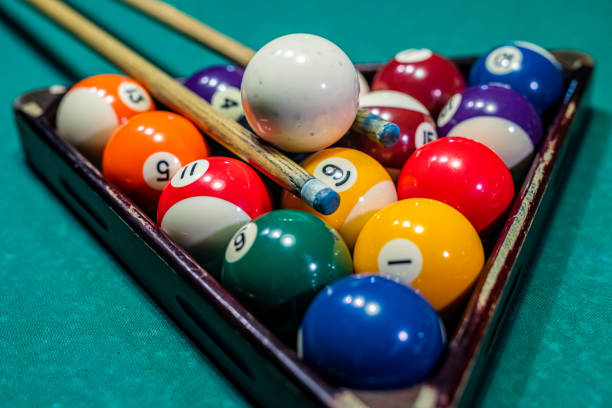 istock beautiful game of colored layers on a green table with holes and table lamps. 1404420004