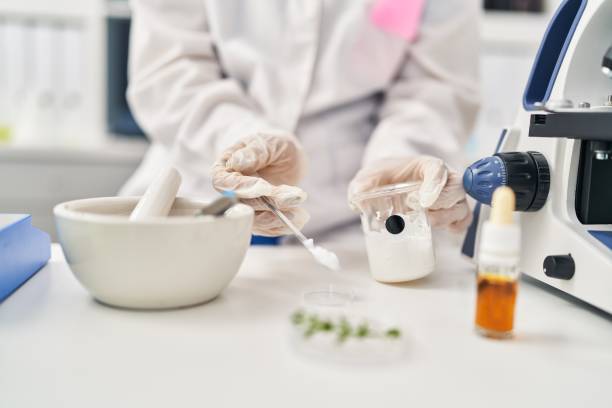 istock Young chinese woman wearing scientist uniform working at laboratory 1404420294