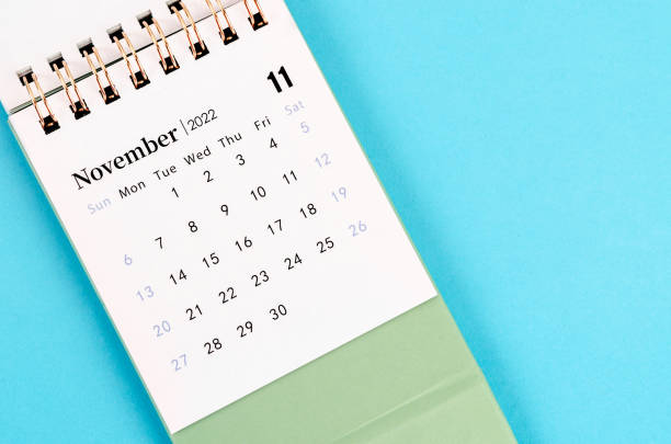 November calendar 2022 on blue background. The November calendar 2022 on blue background. november stock pictures, royalty-free photos & images