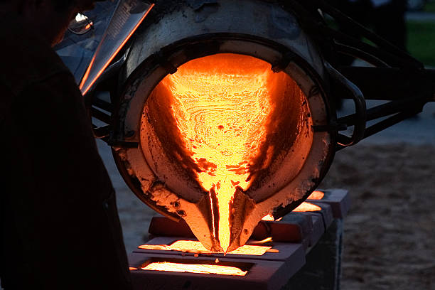 Vulcan's Crucible Pouring molten iron. molten stock pictures, royalty-free photos & images