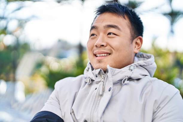 istock Young chinese man smiling confident standing at park 1404420714