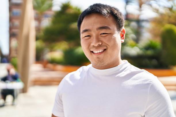 istock Young chinese man smiling confident standing at street 1404420799