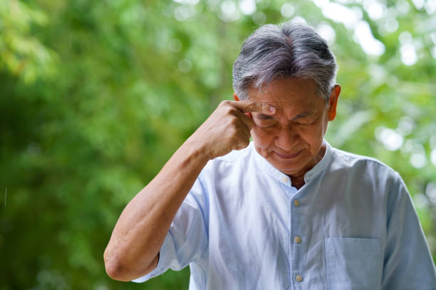 istock Senior man having a headache at outdoors 1404422097