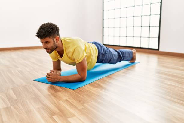istock Young arab sporty man concentrate training abs exercise at sport center. 1404422948