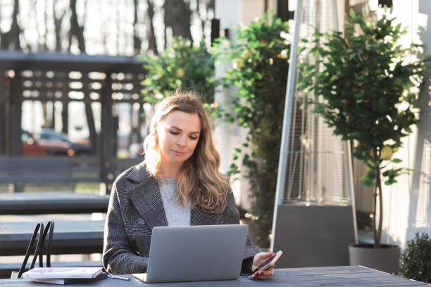 istock Freelancer sitting in modern workspace or office Business woman using modern technology indoor in cafeteria Millennial 1404426249