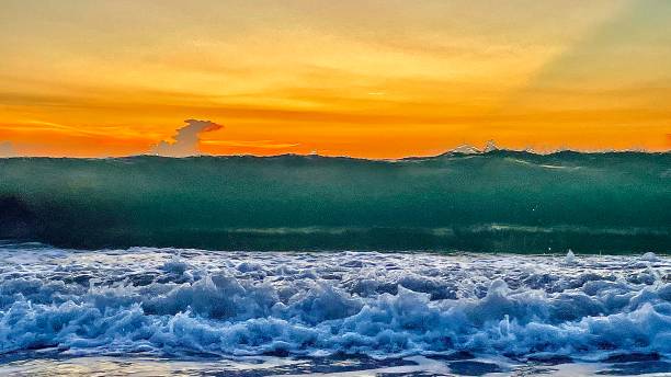 istock Breaking wall of a wave at dusk about to break 1404428069