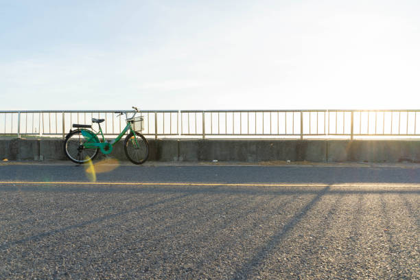 istock Bicycle on the bridge at sunset 1404431026