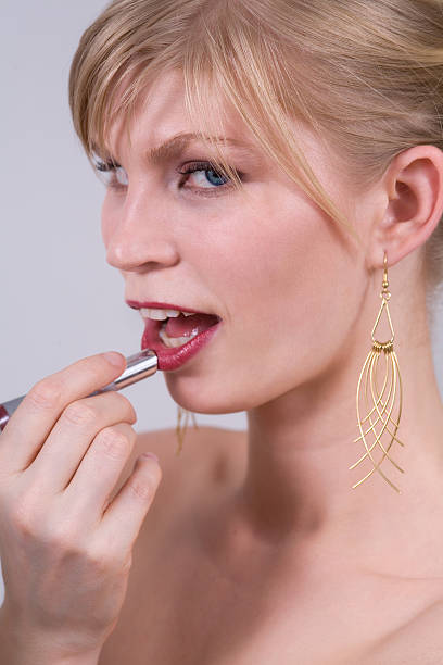 istock Woman Applying Lipstick 140443170