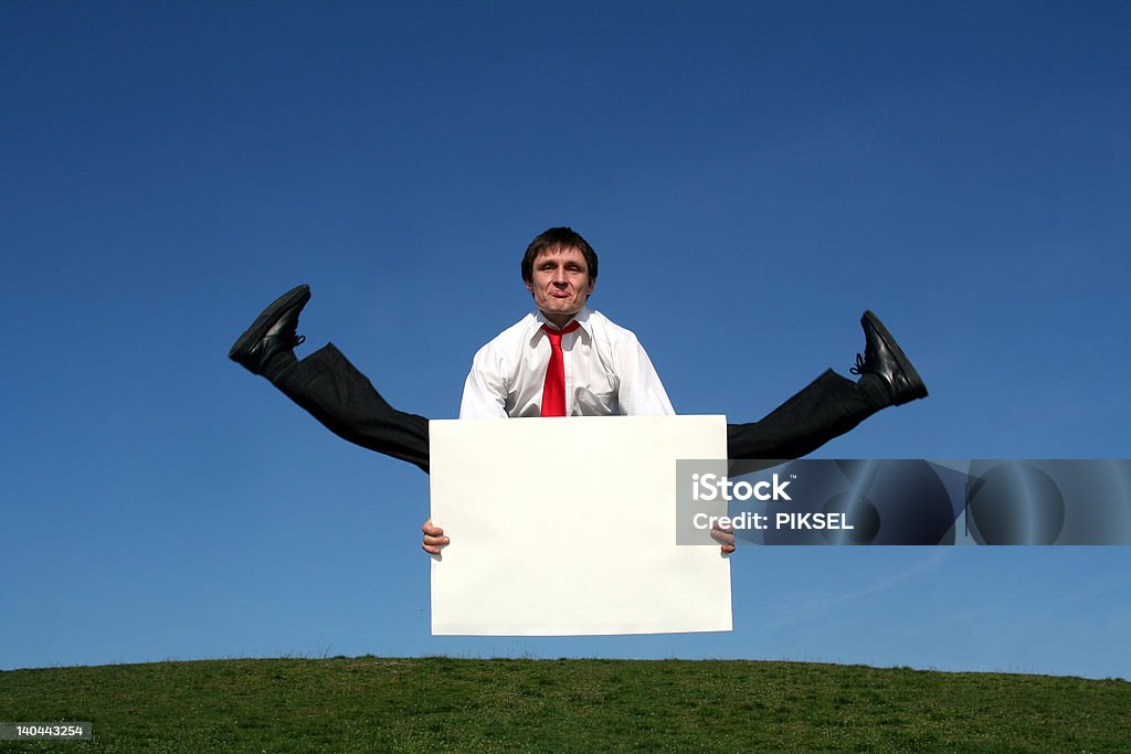 Businessman jumping and holding a blank sign http://www.ufnal.pl/~bolek/feliks.szewczyk.info/foty/album35/business2.jpg Activity Stock Photo