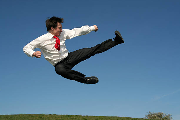 istock Businessman doing a karate kick outdoors 140443280