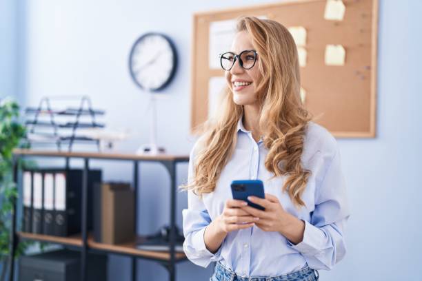 istock Young blonde woman business worker using smartphone at office 1404434063