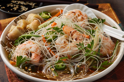 Vietnamese Rice Noodle Soup with  Shrimp, Sliced Carrots, Cucumbers, Jalapeno Peppers, Cilantro and a Spring Roll