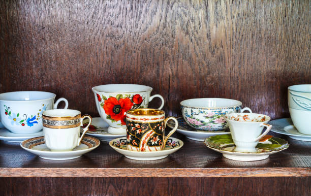Variety on cupboard shelf Shelf in cupboard with different kinds of porcelain cofee cups tea cup and saucer stock pictures, royalty-free photos & images